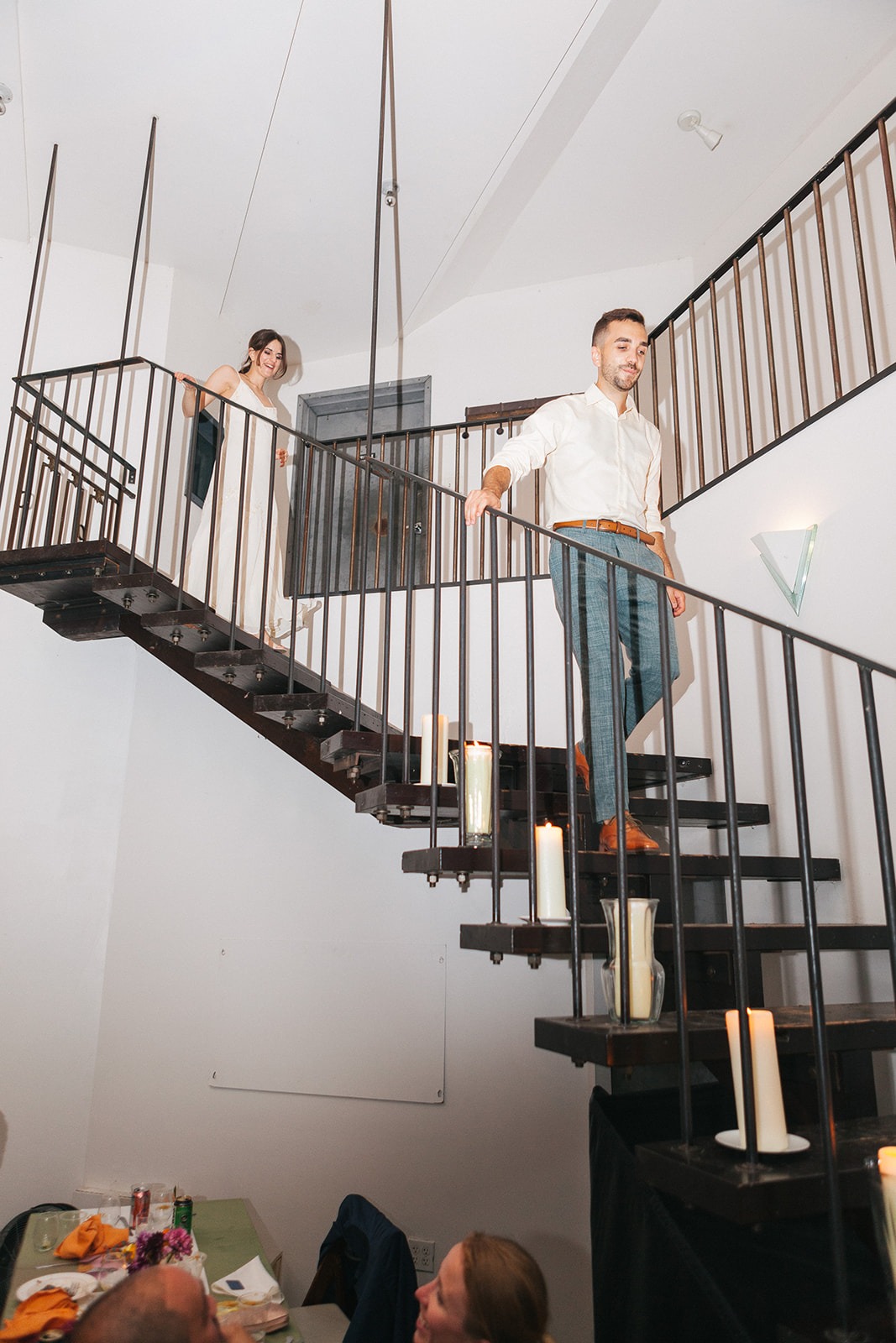 Couple walking down stairs with candles